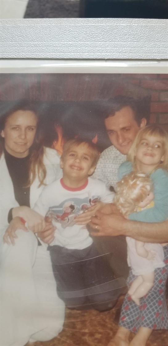 A family enjoys a cozy evening by the fireplace, sharing warmth, smiles, and memories.