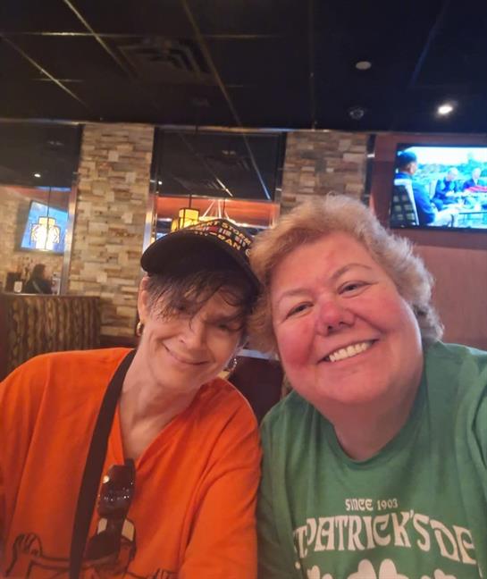 Two women sitting together smiling