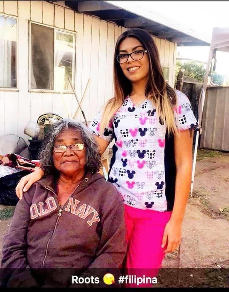 Two women enjoy a moment together outside, highlighting their familial connection and heritage.