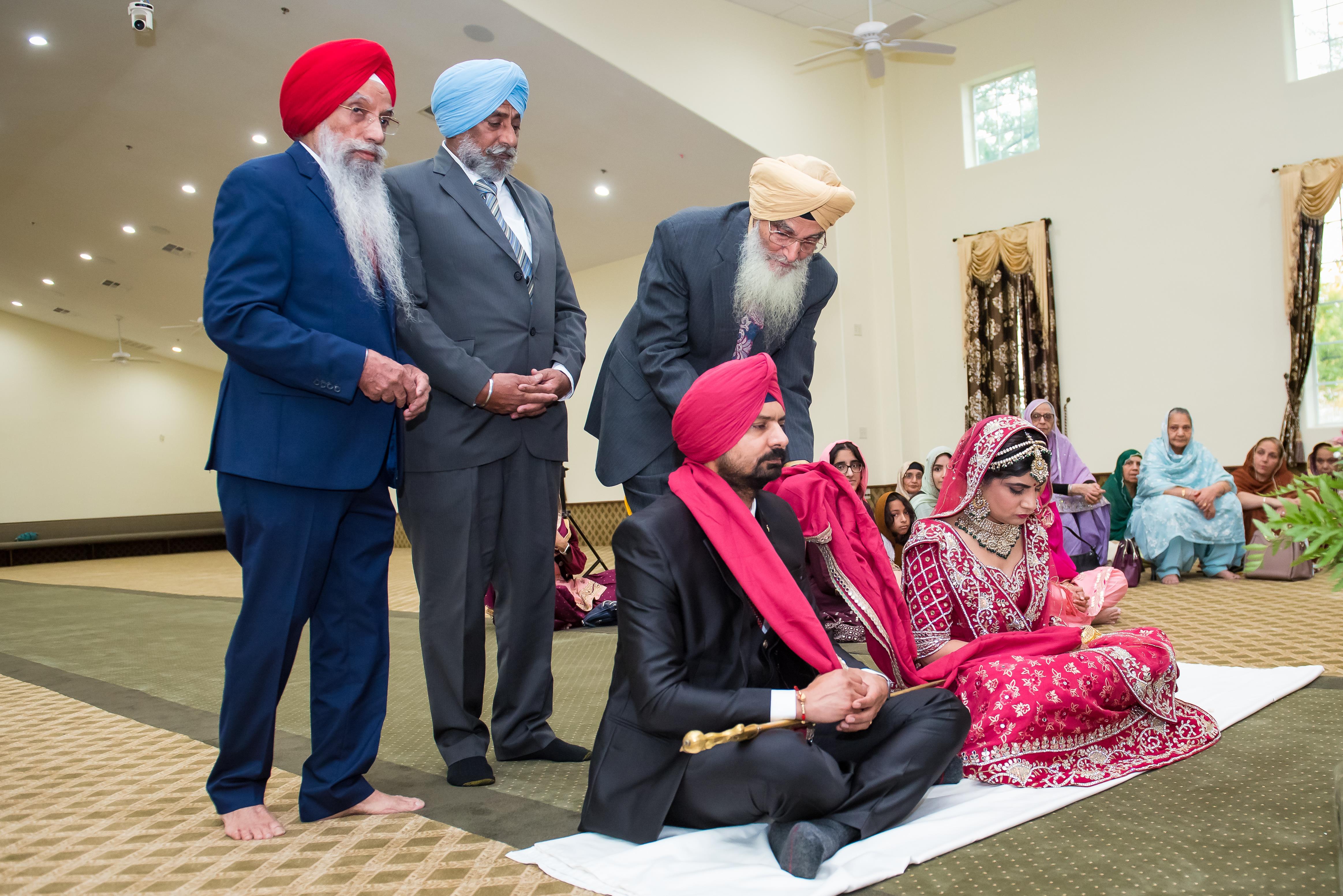Family gathered for a Sikh wedding, showcasing cultural attire and joyful interactions.
