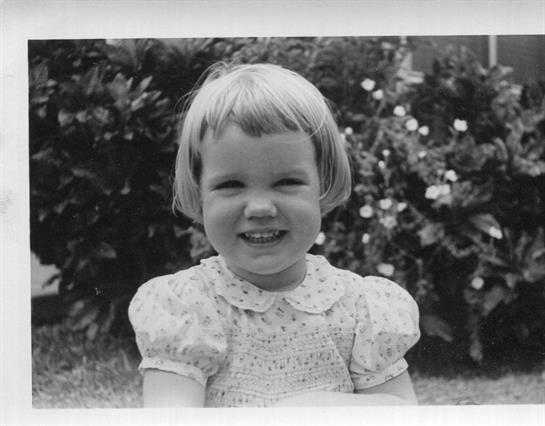 A close-up of a little girl smiling
