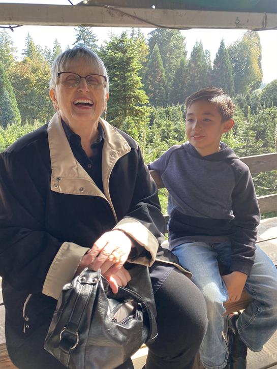 A woman and boy sitting on a bench