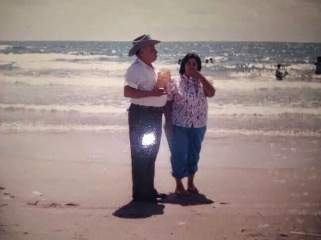 A man and woman standing on a beach