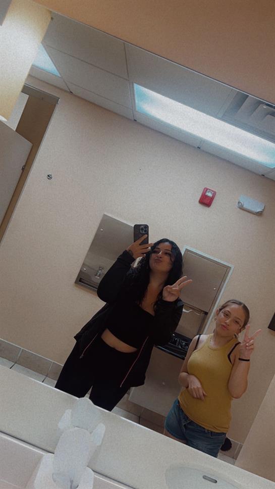 A woman taking a selfie with another woman