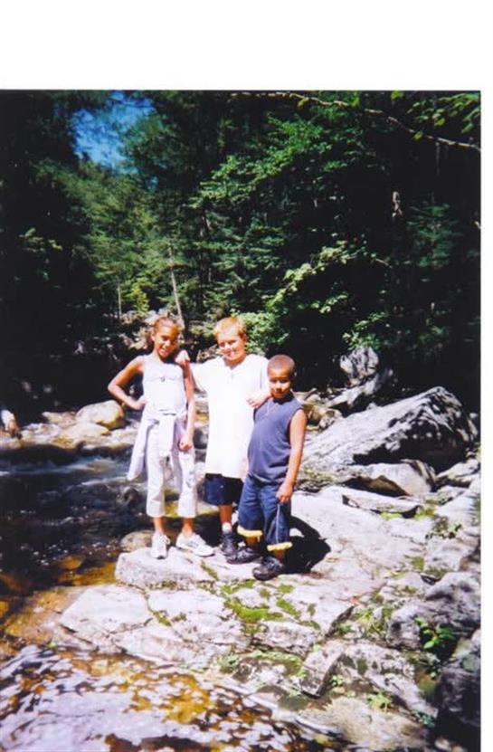 A group of children standing on rocks