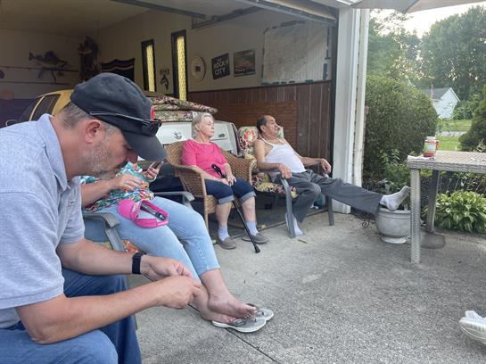 A group of people sitting on chairs outside