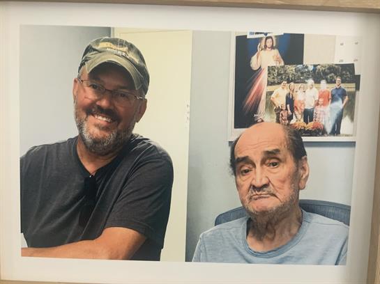 A man and a man sitting in a chair