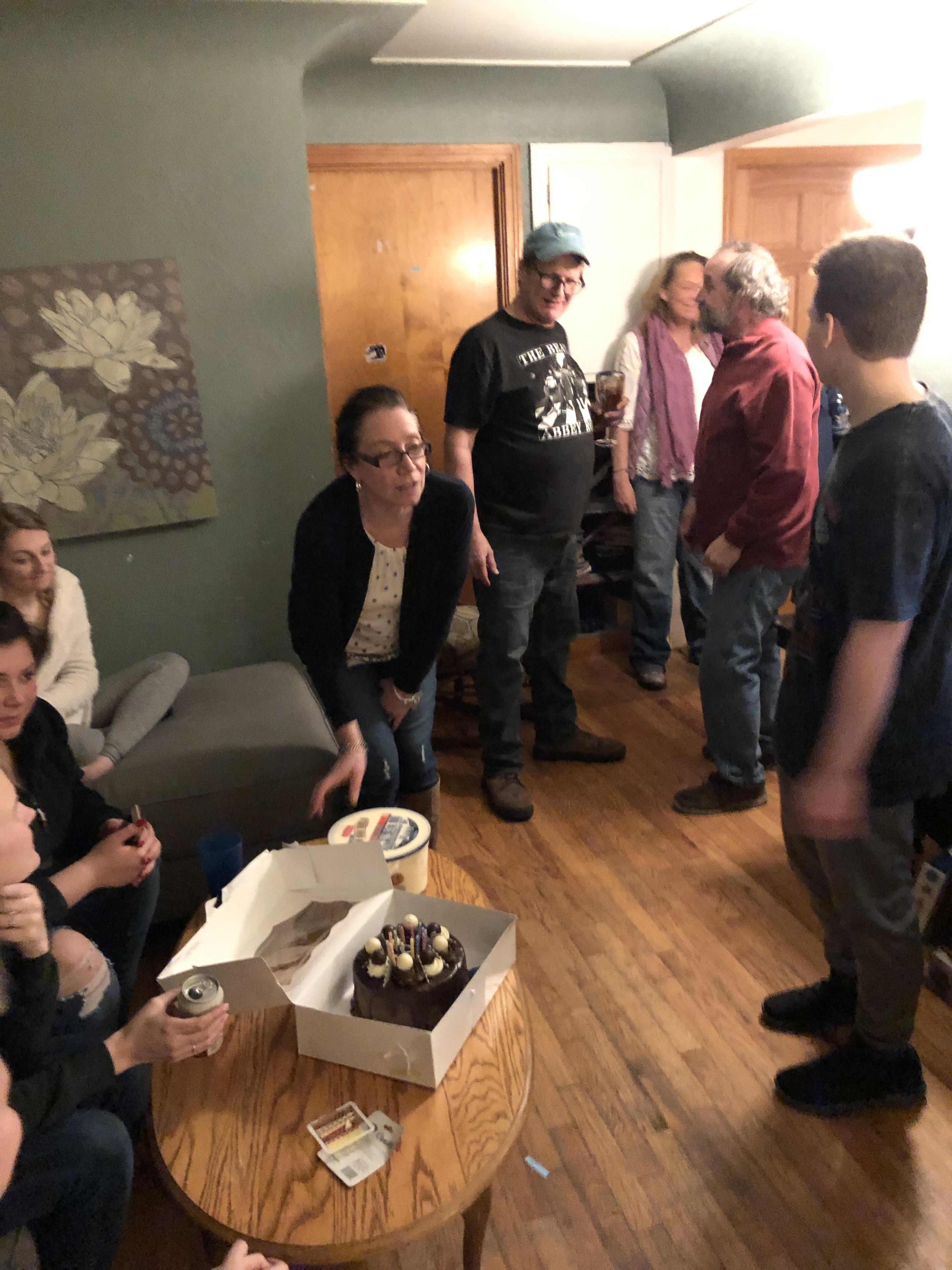 Friends and family celebrate a joyful birthday at a cozy gathering full of laughter.