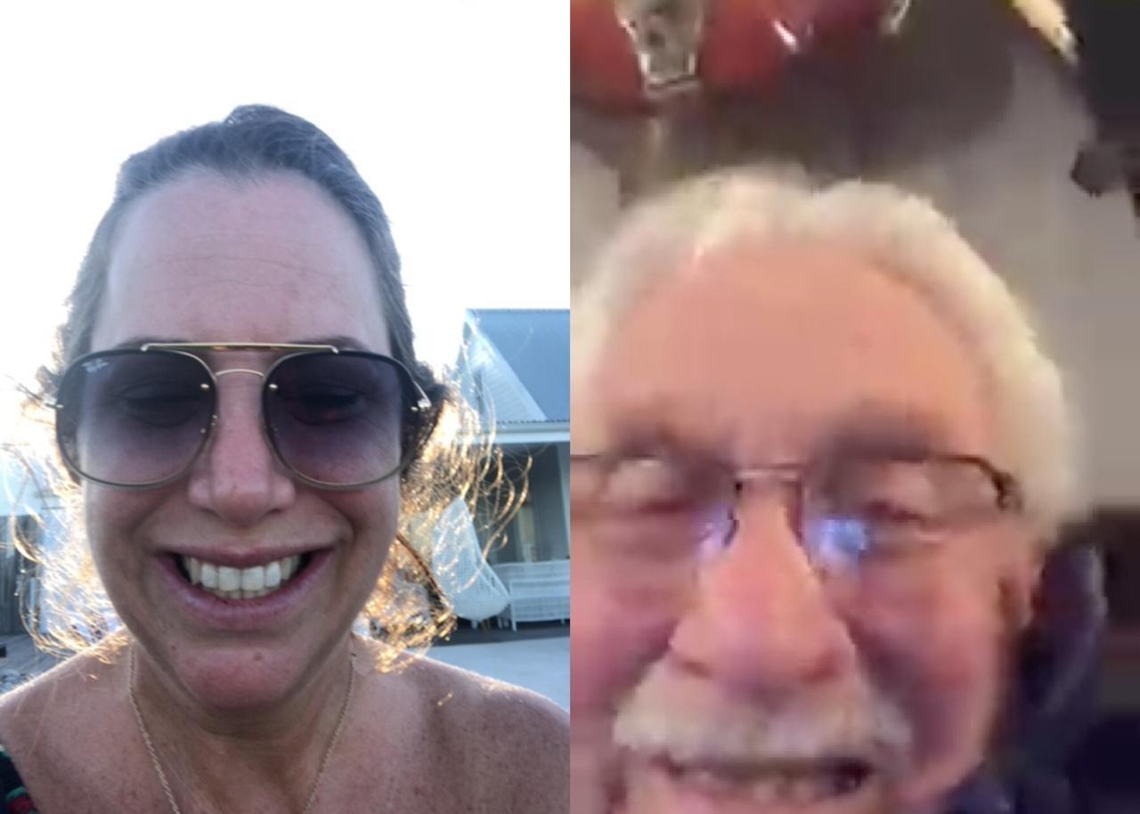 A cheerful woman takes a sunny selfie with an elderly man, capturing their joyful bond.