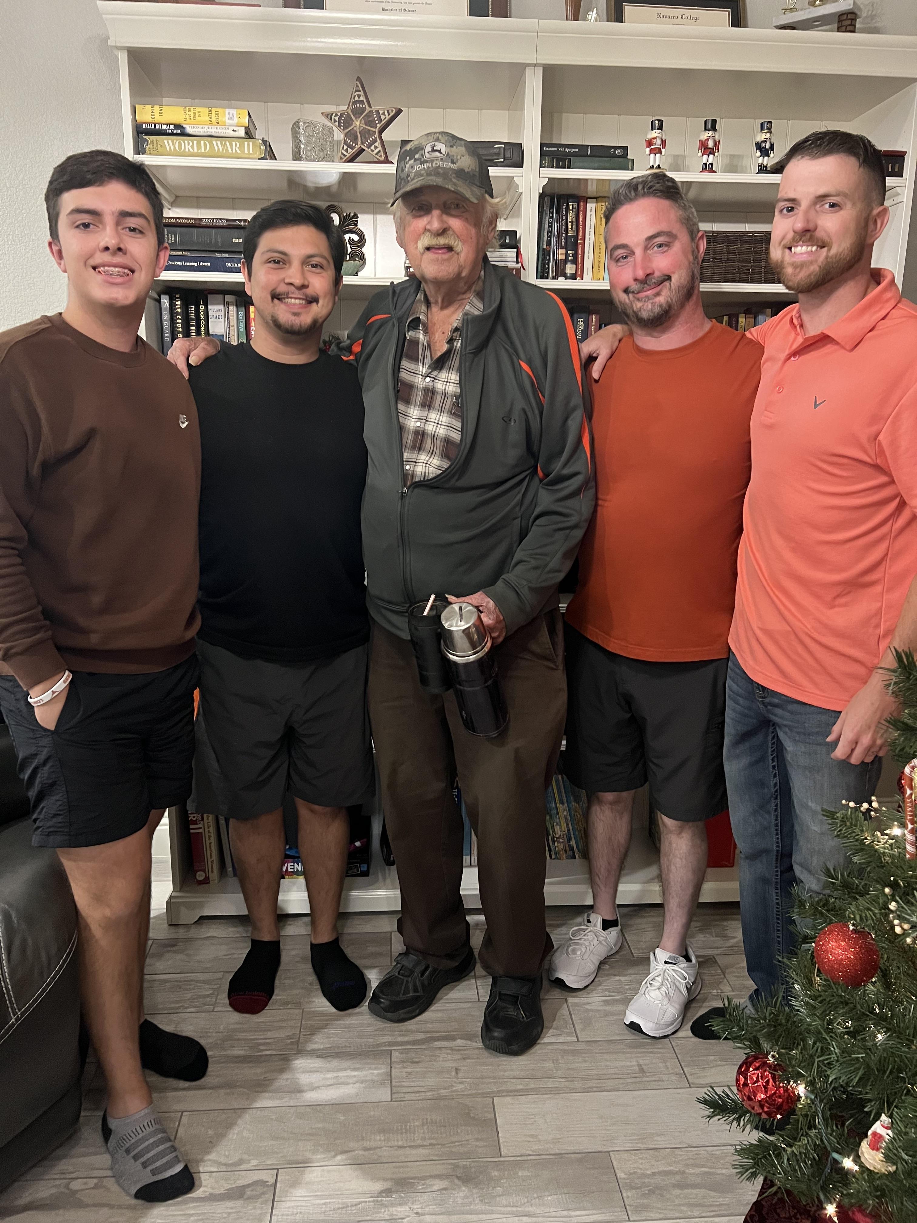 A joyful family celebrates together with smiles, showcasing their bond during the holiday season.