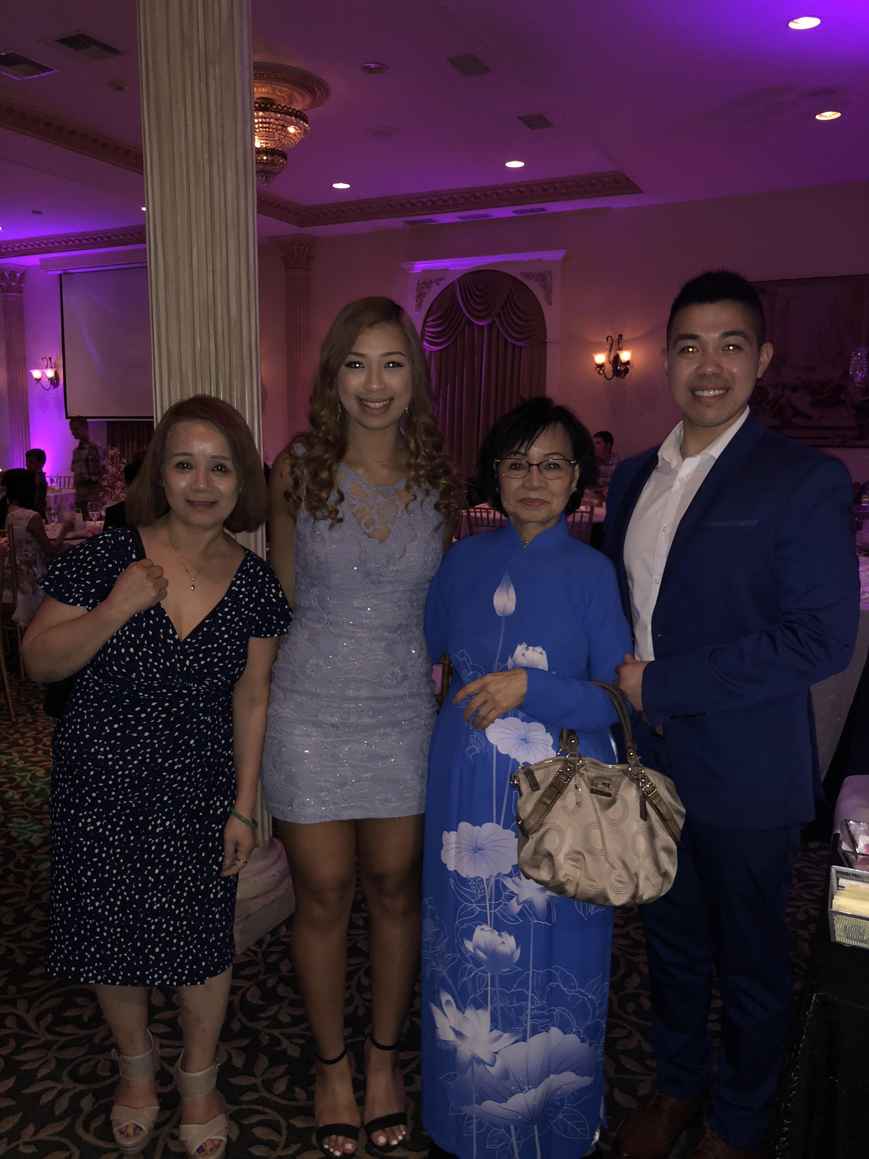 Groups of friends and family dress elegantly, enjoying a cheerful celebration in a lively venue.