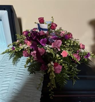 A casket with flowers on it
