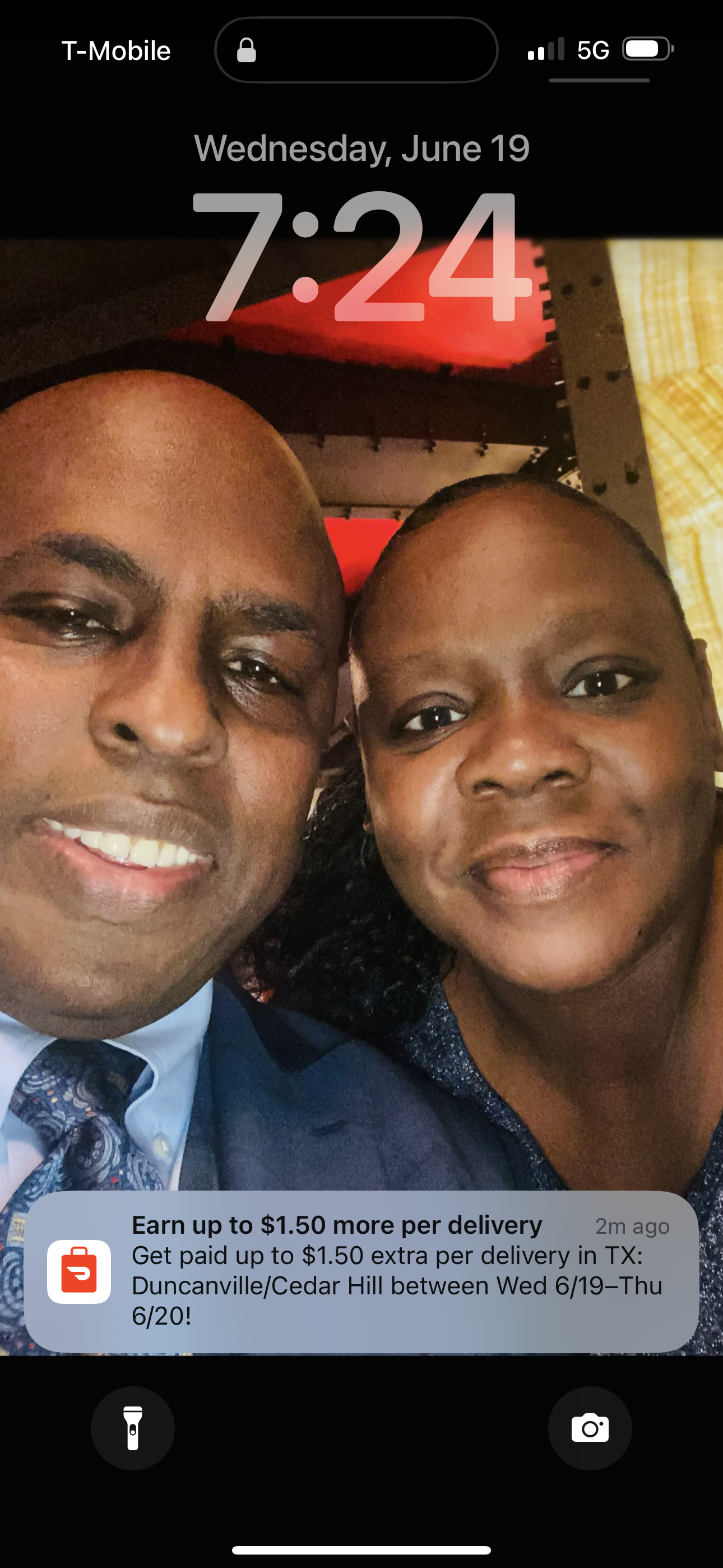 Two individuals share a joyful moment, smiling warmly at the camera in a vibrant indoor location.