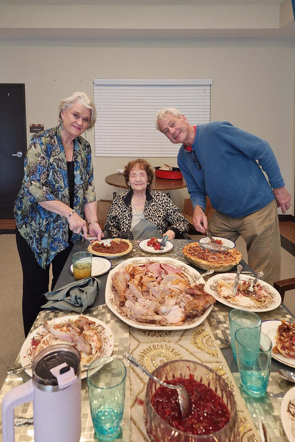 Friends and family enjoy a large spread of food together, celebrating in a warm setting.