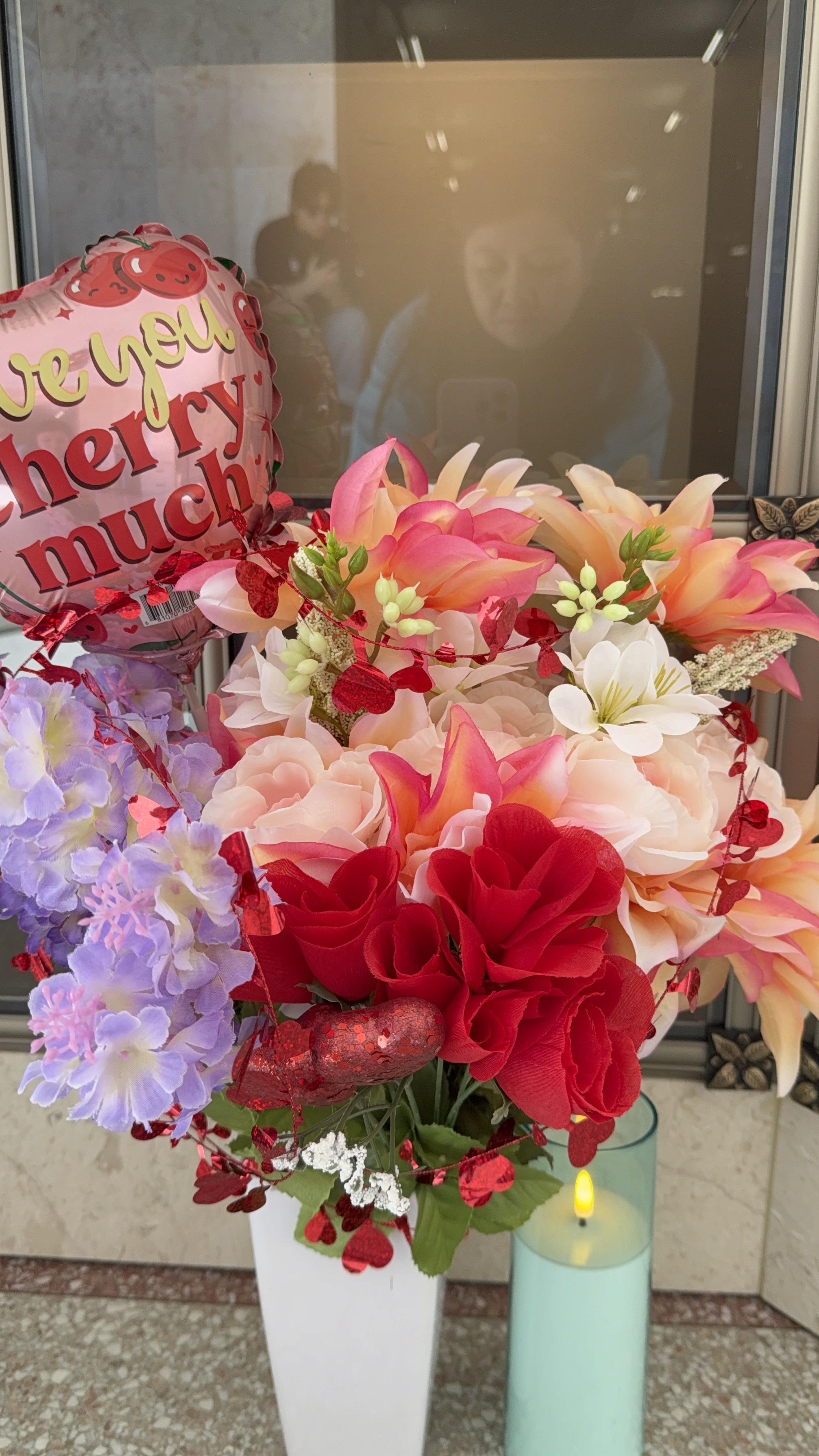 A bouquet of flowers and a balloon