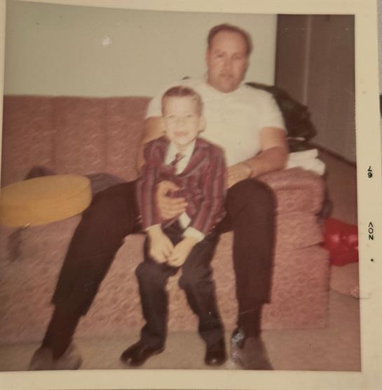 A man and child sitting on a couch