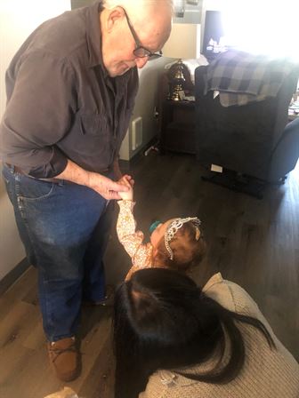 A man holding a child's hand