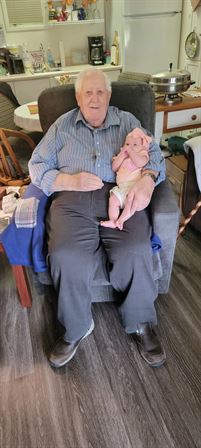 An old man holding a baby