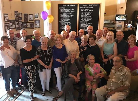 A cheerful gathering of seniors enjoying each other's company during a festive event.