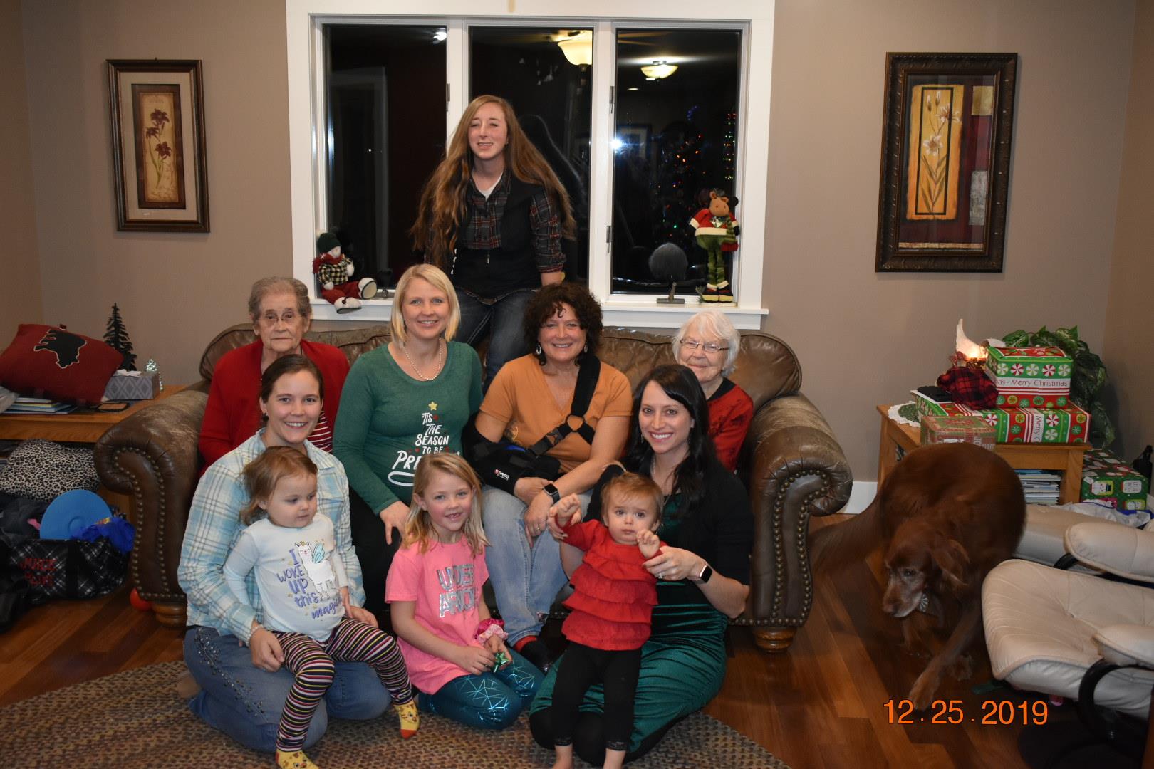 Friends and family enjoy a holiday gathering with children playing and adults socializing together.