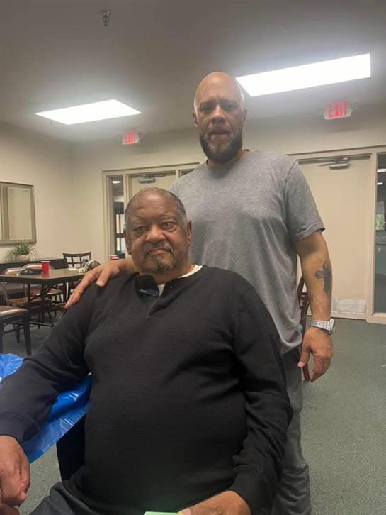 A man standing next to another man