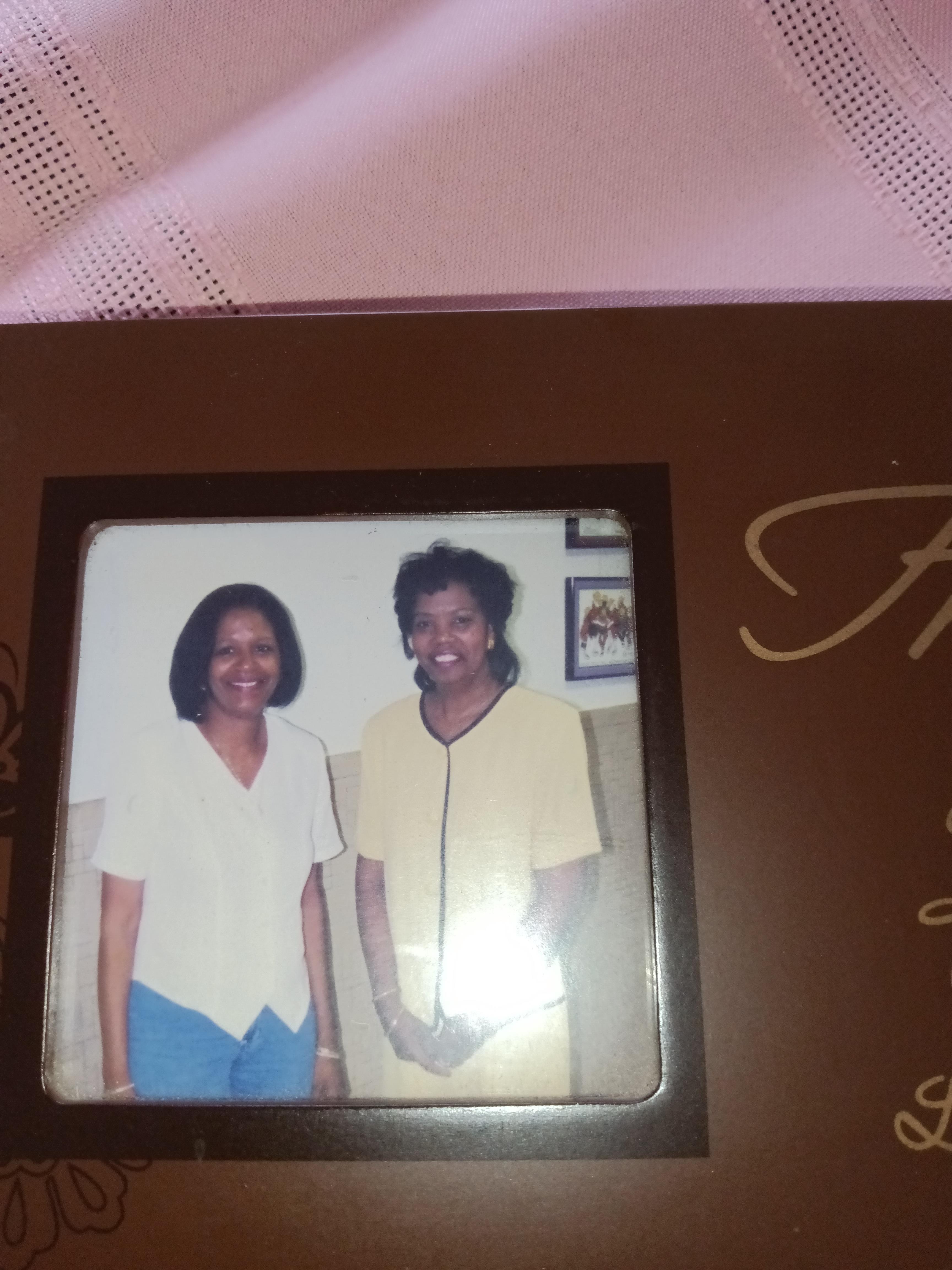 Two friends standing side by side, sharing joyful smiles in a cozy space.