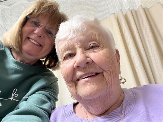 A woman and a woman taking a selfie