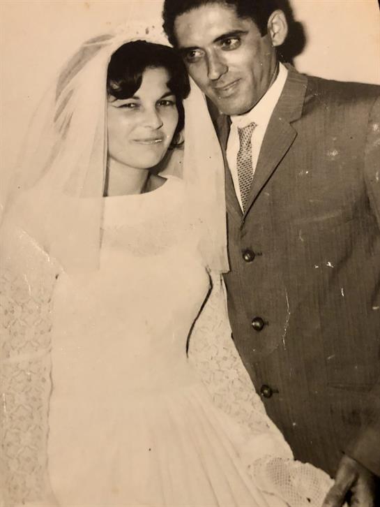 A happy couple in elegant attire celebrates their wedding day together.