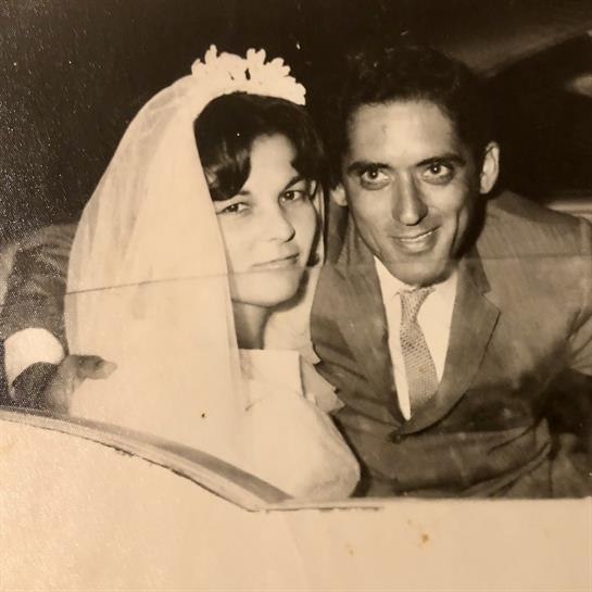 Newlyweds pose together in a car, radiating happiness and love after their wedding ceremony.