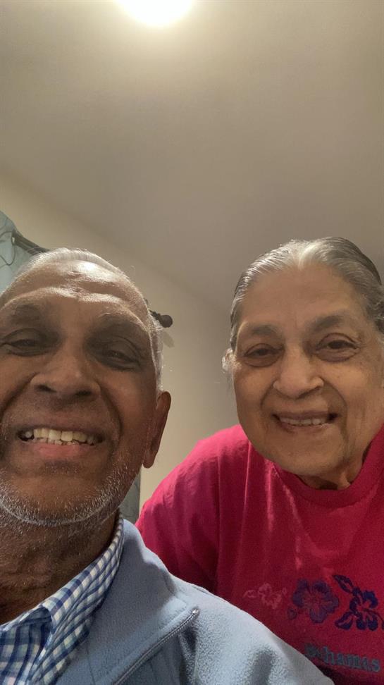 Elderly couple takes a joyful selfie together, radiating happiness and love at home.