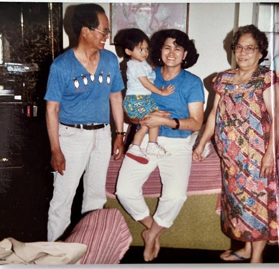 Relatives enjoy quality time together while sharing laughter and conversation in their living room.