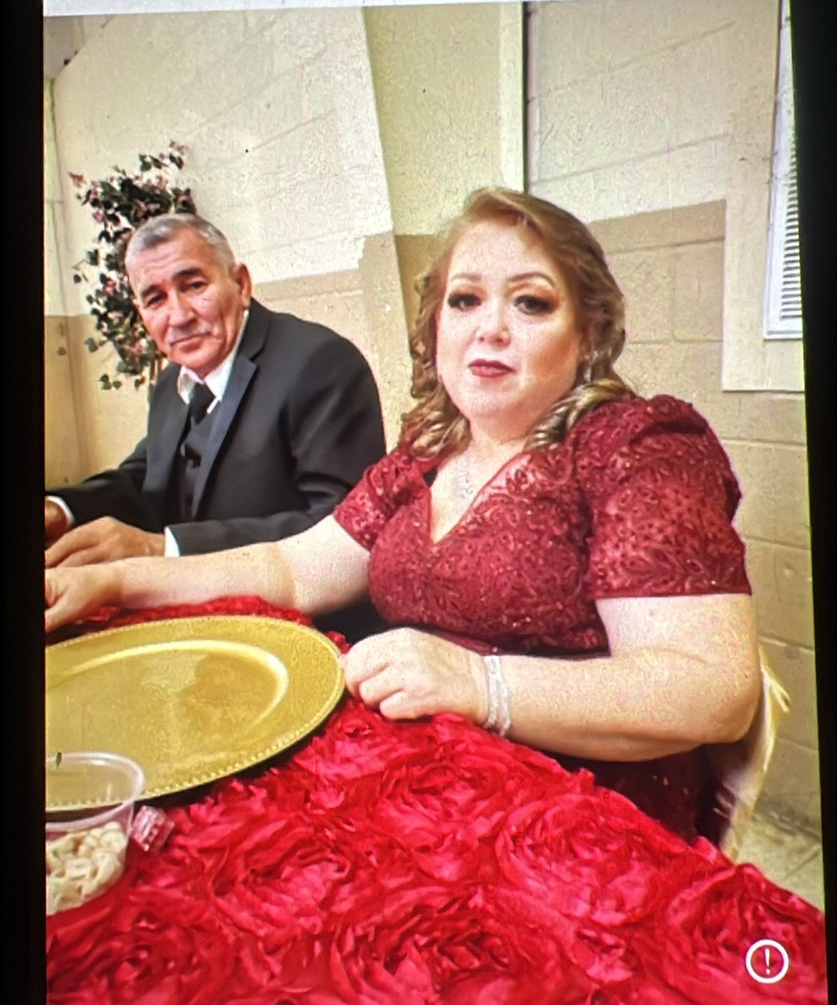 A woman sitting at a table with a man in a suit