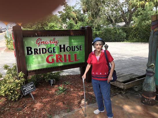 A woman standing in front of a sign