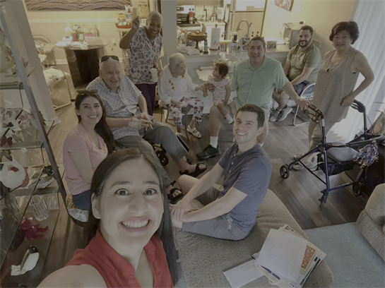 Family members enjoy each other's company in a joyful gathering at a cozy home.