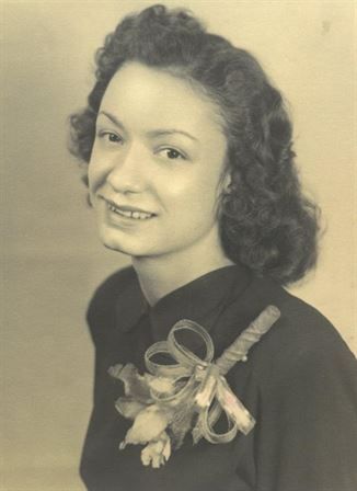 A woman with curly hair wearing a black shirt