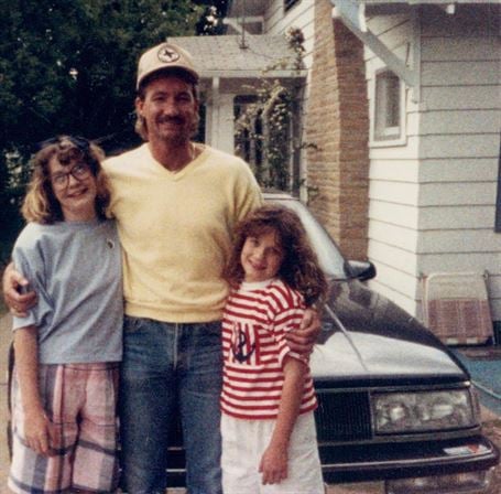 A man and two children posing for a picture
