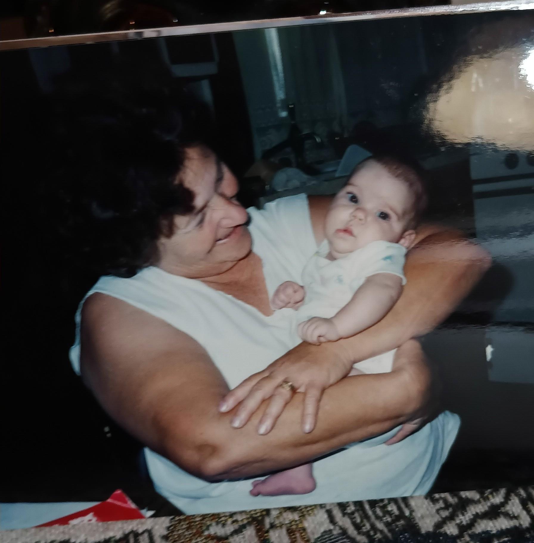 A loving grandmother cherishes her grandchild in a warm and inviting home environment.