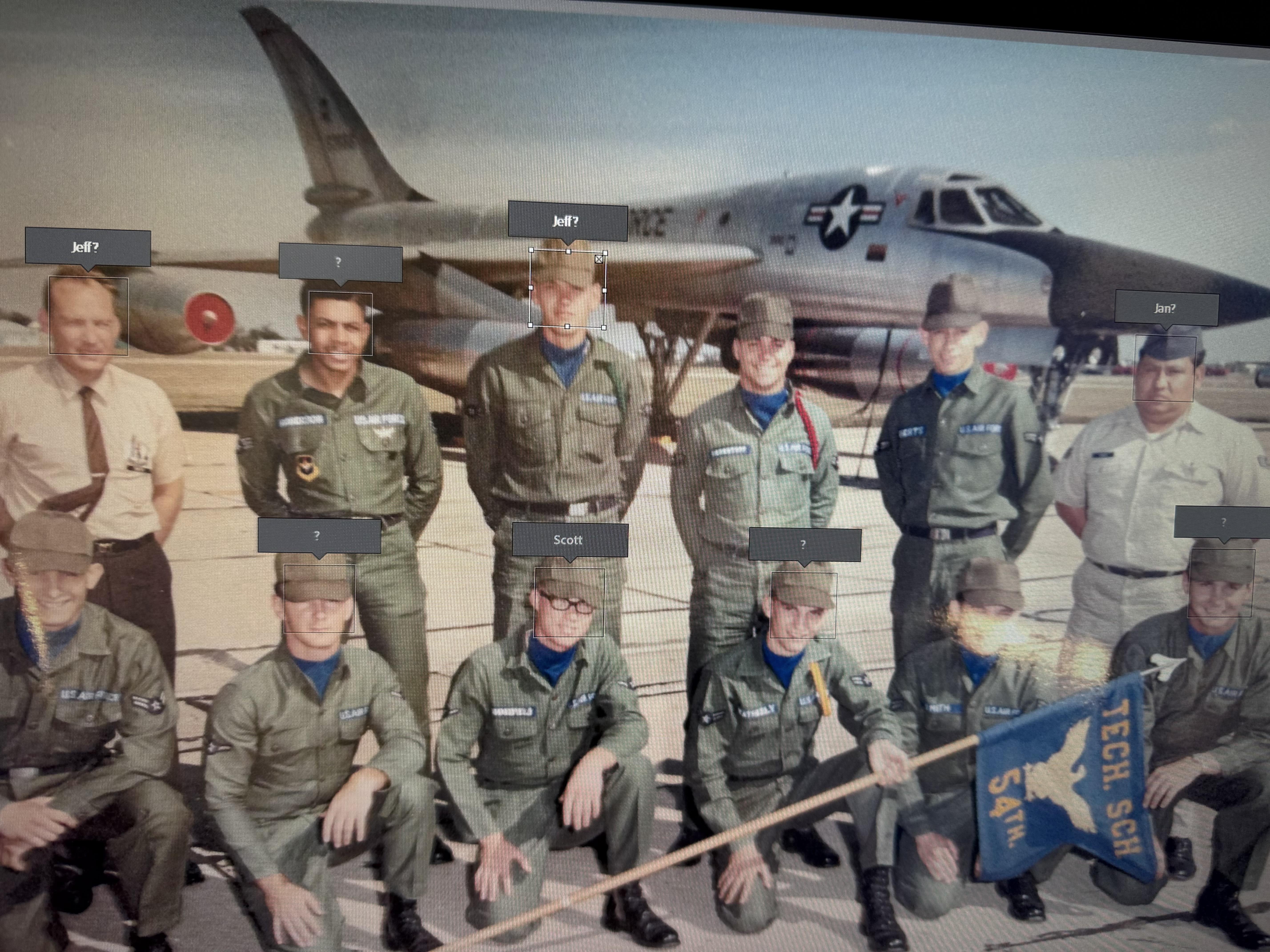 Military crew poses with an aircraft on the tarmac, showcasing teamwork and pride.