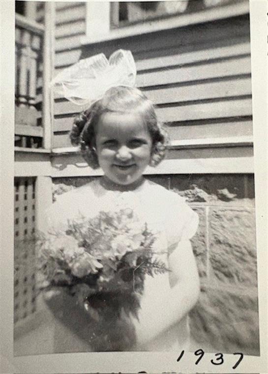 A girl holding flowers and smiling