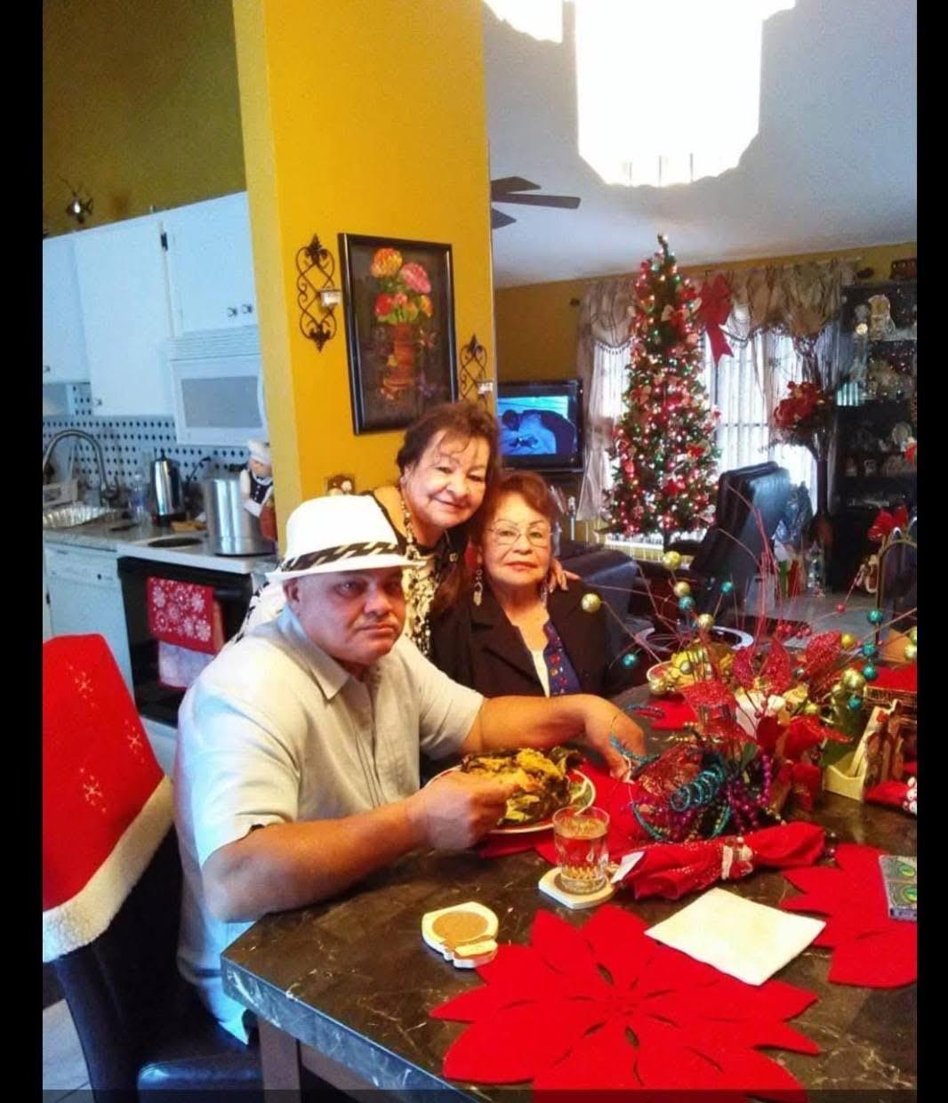 Family members enjoy each other's company during a holiday meal amid festive decor.