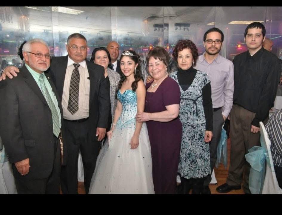 Loved ones come together to celebrate a young girl in a formal dress, sharing joy and memories.