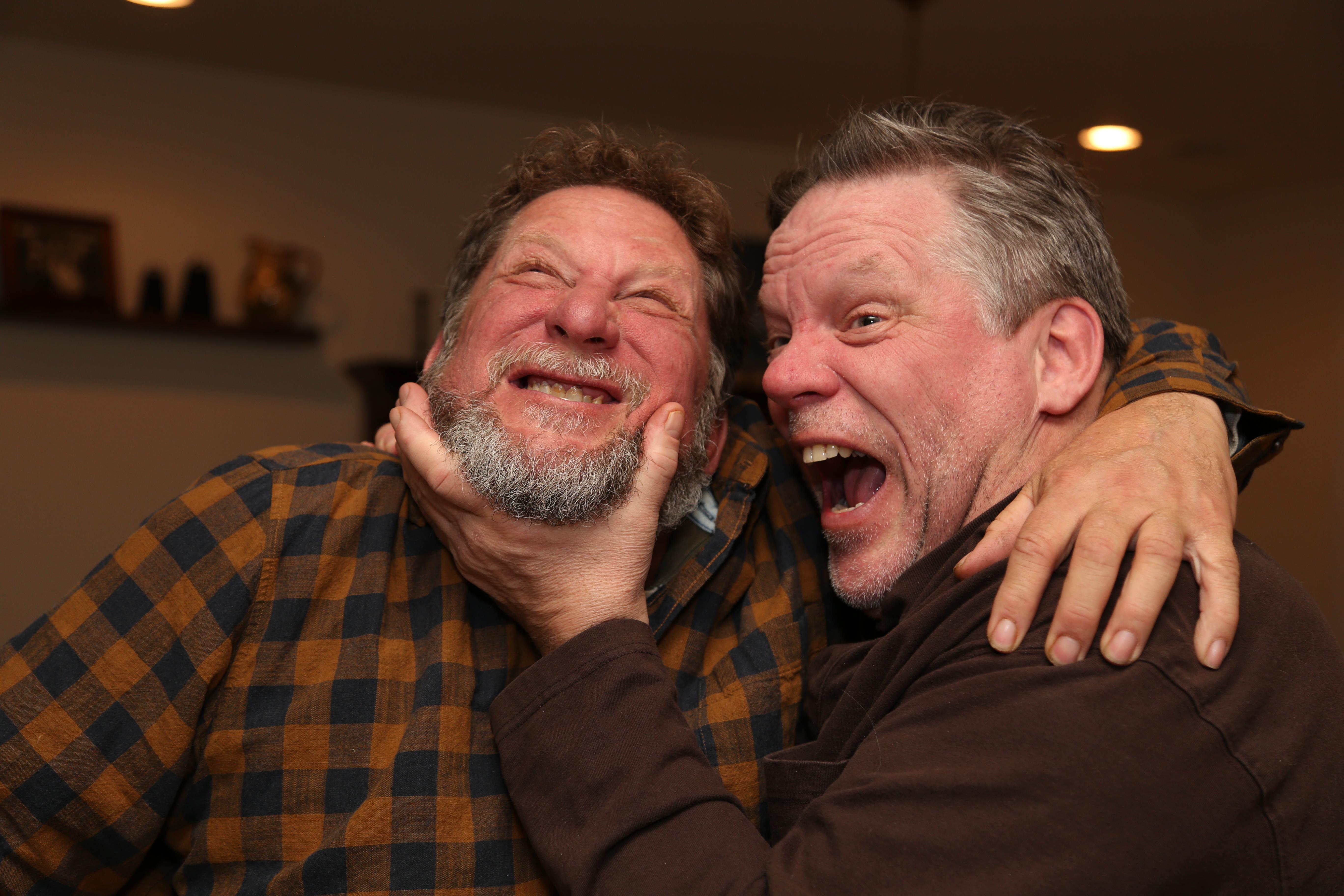 Friends share a lighthearted moment, laughing and engaging warmly in a cheerful atmosphere.