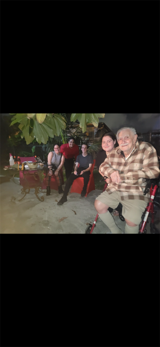 Loved ones enjoy each other's company during a casual evening gathering outdoors.