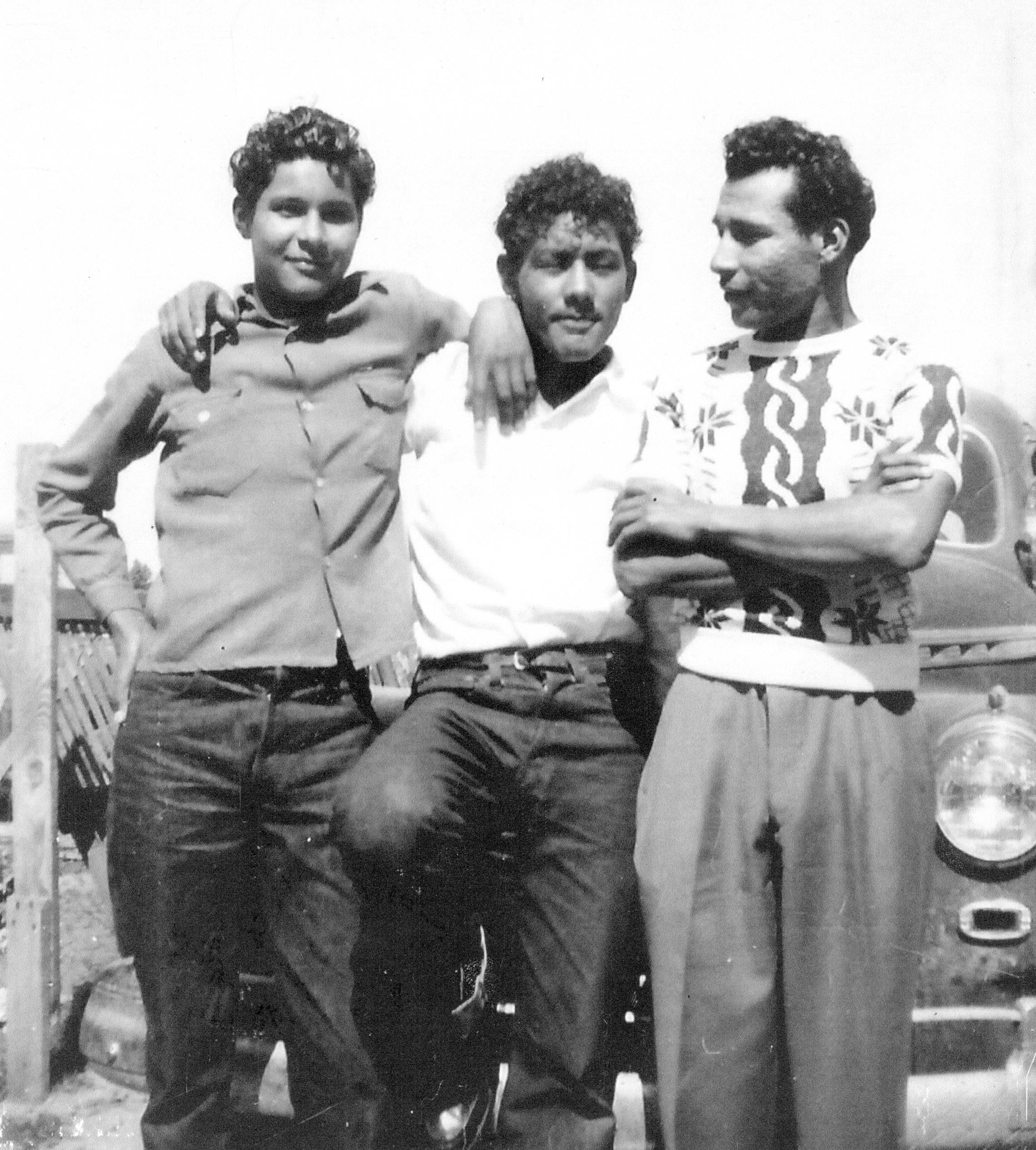 Three friends enjoy a relaxed moment, showcasing camaraderie and fashion of the 1950s.