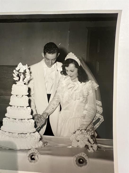 A man and woman cutting a wedding cake