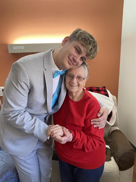 A man in a suit holding a woman's hand