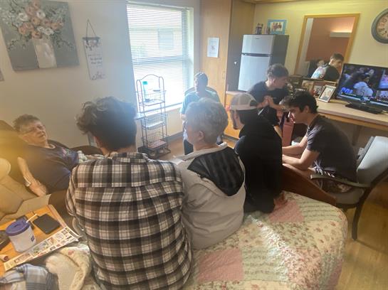 A group of people sitting on a bed