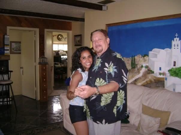 Two individuals share a happy moment in a warmly decorated living area filled with personality.