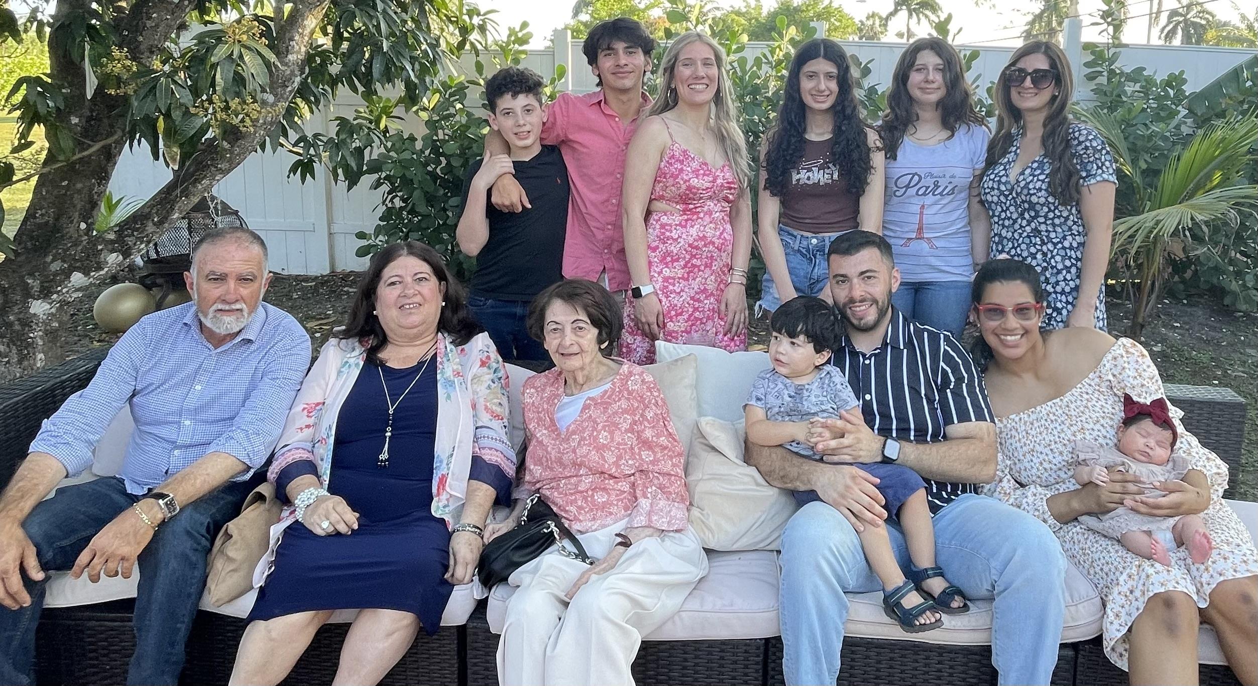 Group of family members gather in a garden for a joyful reunion, celebrating bonds and memories.