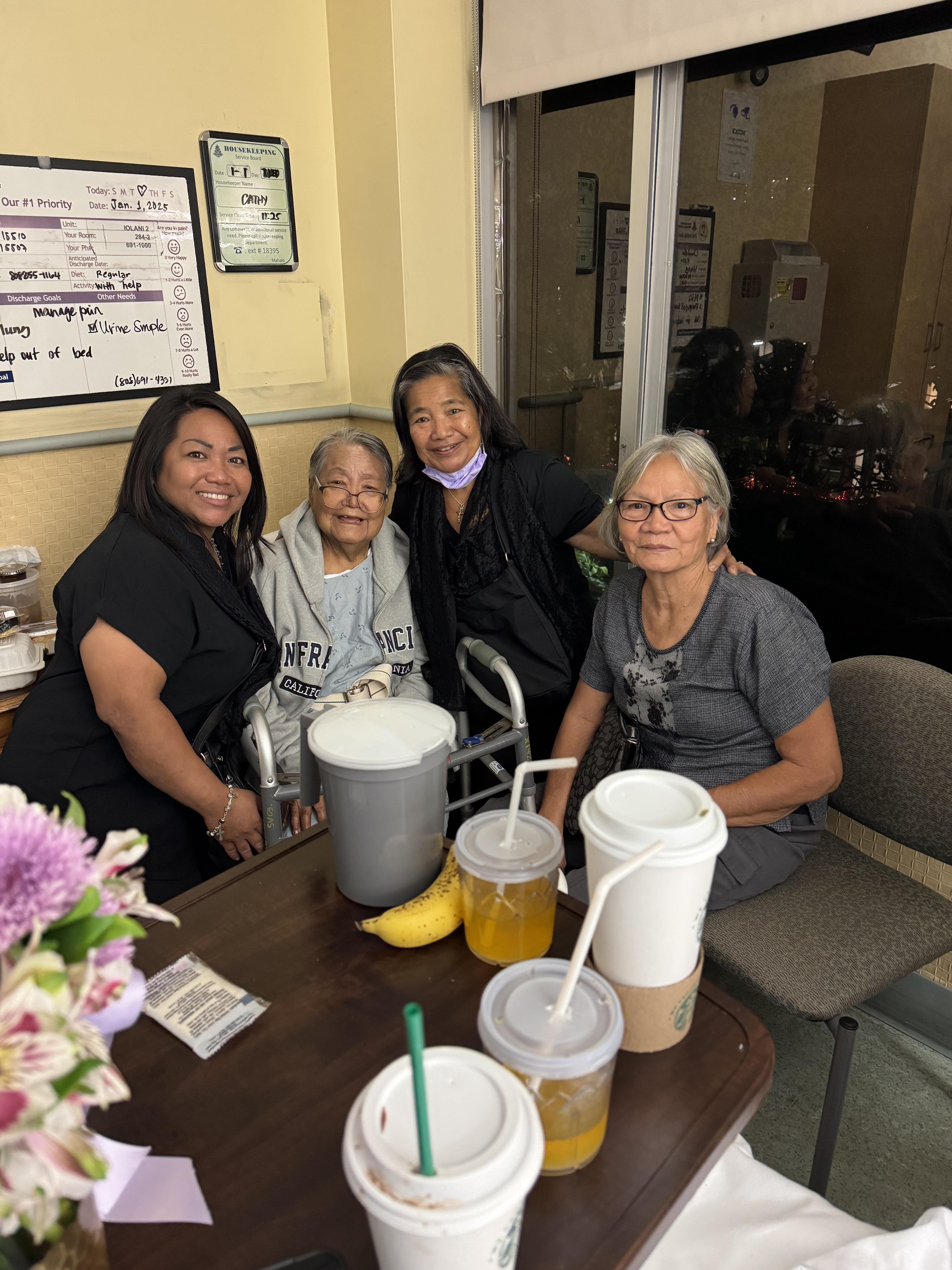 Four friends sit together, sharing drinks and enjoying quality time in a cozy cafe setting.
